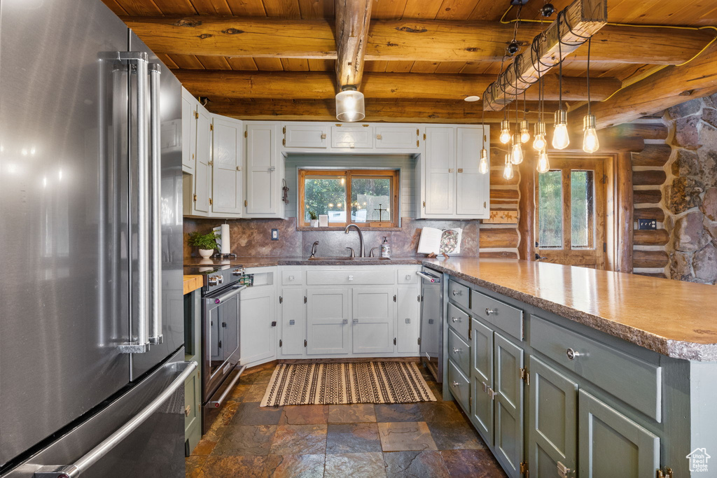 Kitchen featuring white cabinets, wooden ceiling, stainless steel appliances, kitchen peninsula, and beam ceiling