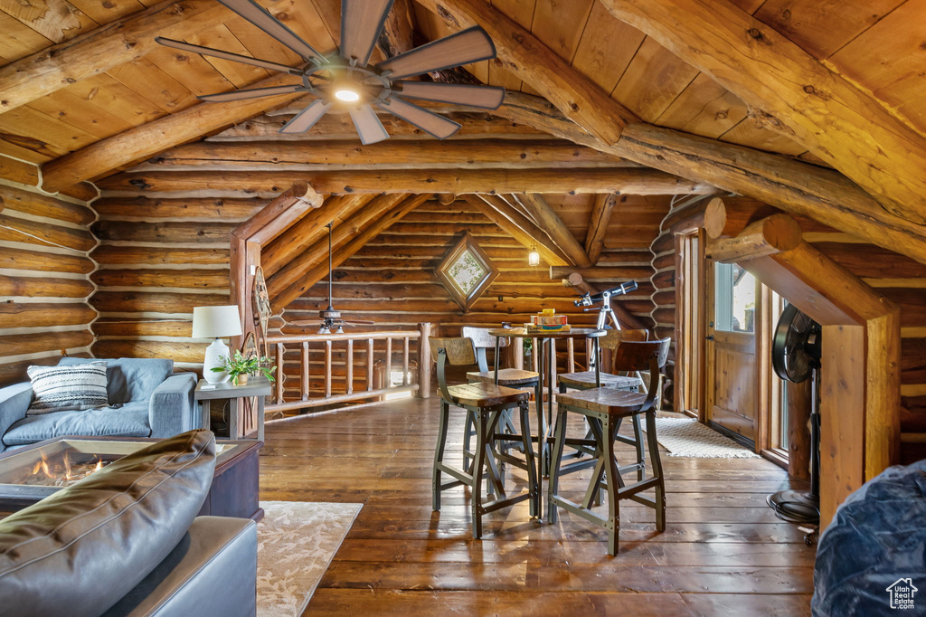 Dining room featuring wood ceiling, vaulted ceiling with beams, ceiling fan, and dark hardwood / wood-style floors