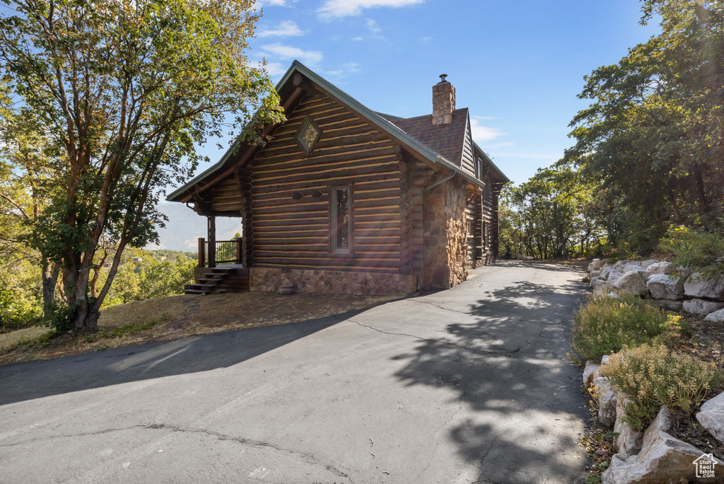 View of side of property featuring covered porch