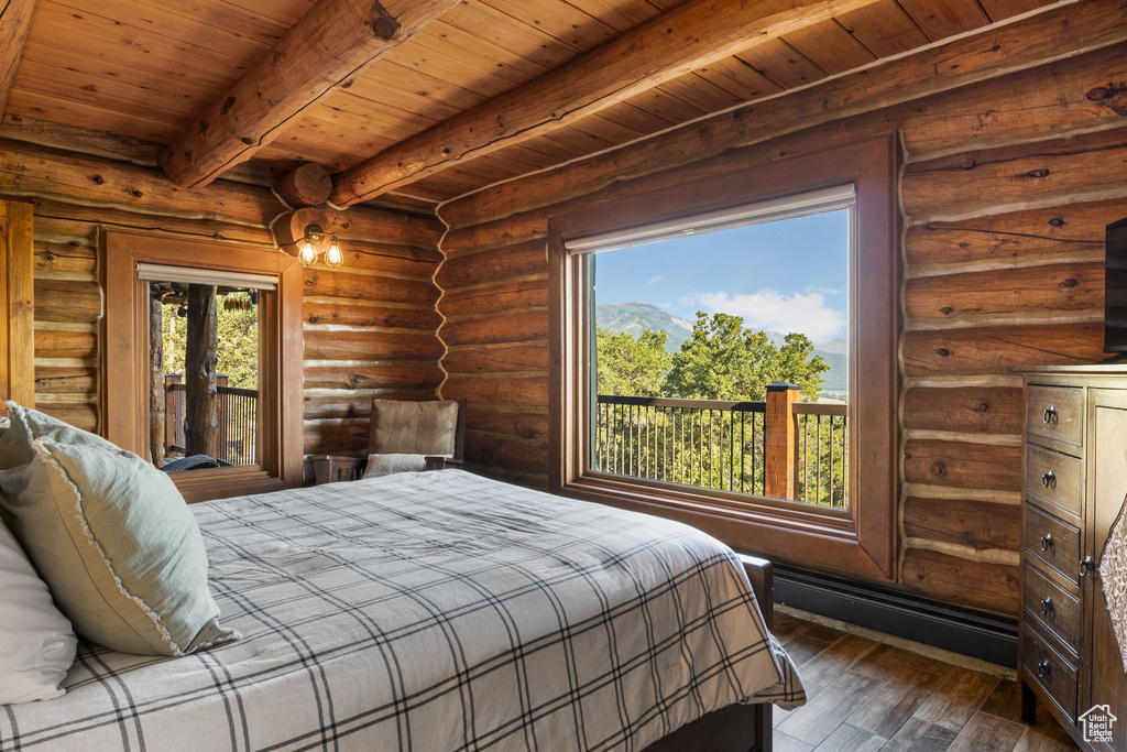 Bedroom with dark wood-type flooring, multiple windows, wood ceiling, and beamed ceiling