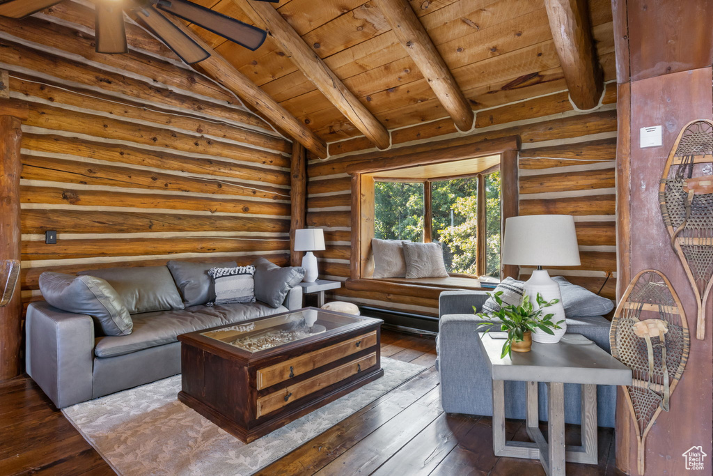 Living room with wood ceiling, rustic walls, ceiling fan, dark hardwood / wood-style floors, and lofted ceiling with beams