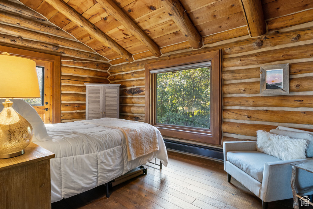 Bedroom with wooden ceiling, dark wood-type flooring, lofted ceiling with beams, and rustic walls