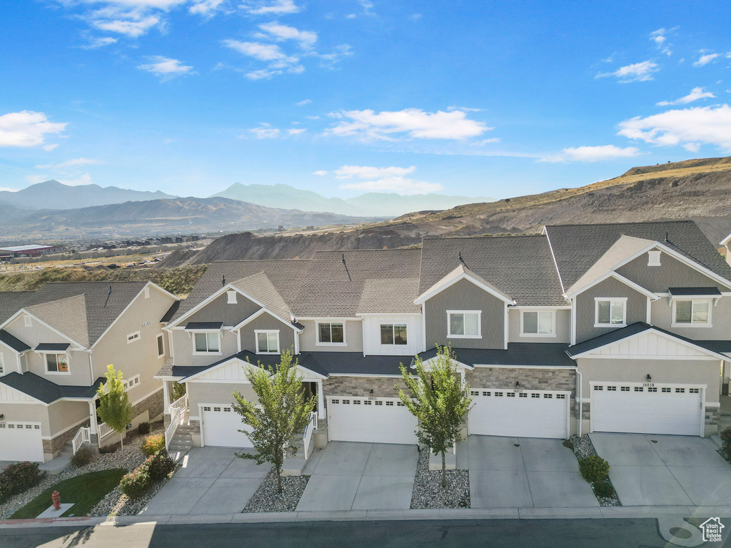 View of front of property with a mountain view and a garage