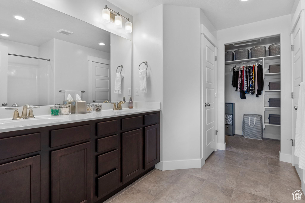 Bathroom with tile patterned floors and vanity