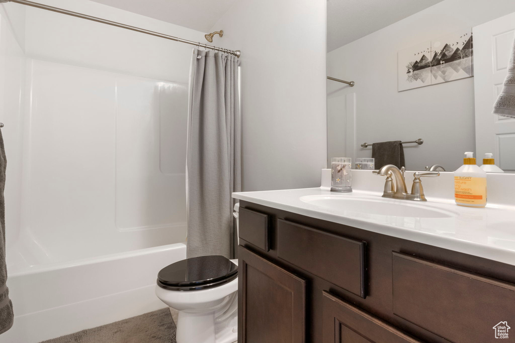 Full bathroom with vanity, toilet, and shower / tub combo