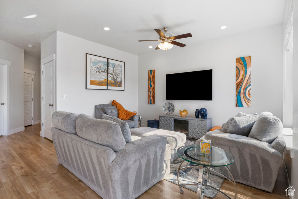 Living room featuring light wood-type flooring and ceiling fan