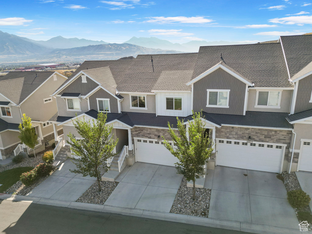 Multi unit property with a mountain view and a garage