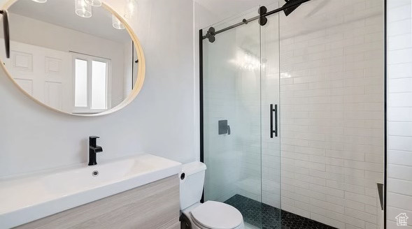 Bathroom with vanity, toilet, and walk in shower