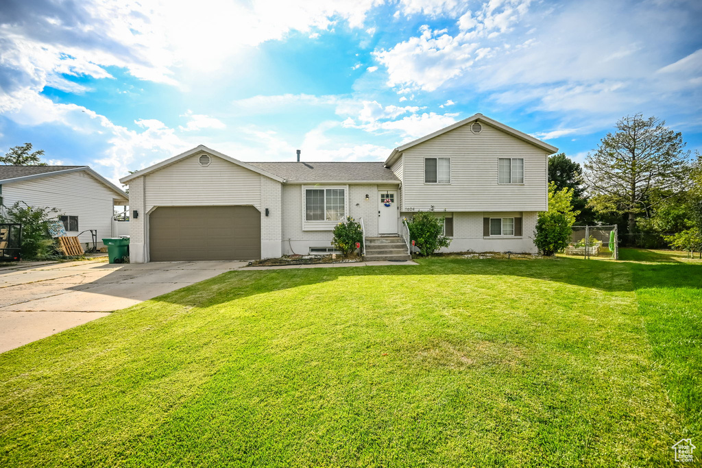 Split level home with a front yard