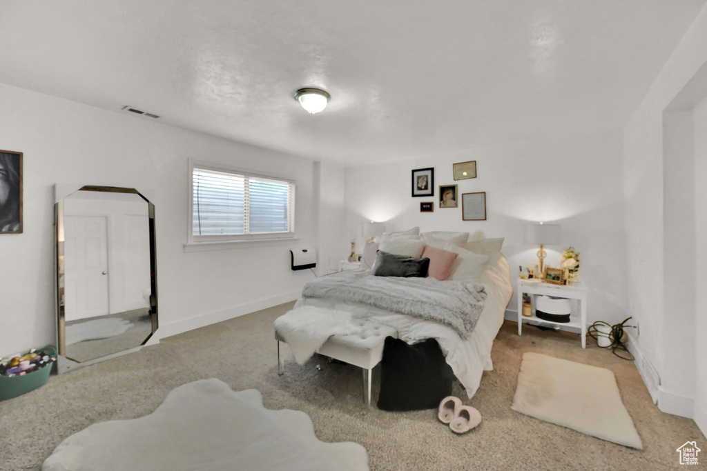 Bedroom with light carpet