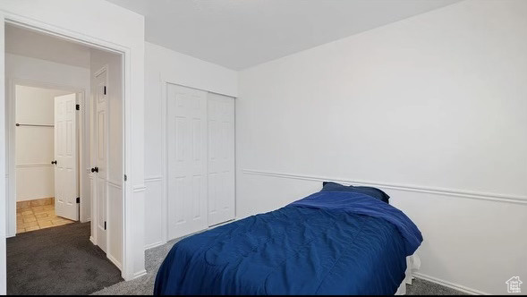 Bedroom featuring carpet and a closet