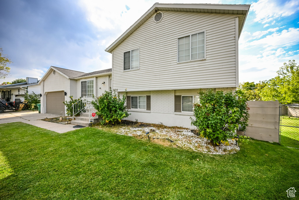 Exterior space featuring a front yard and a garage