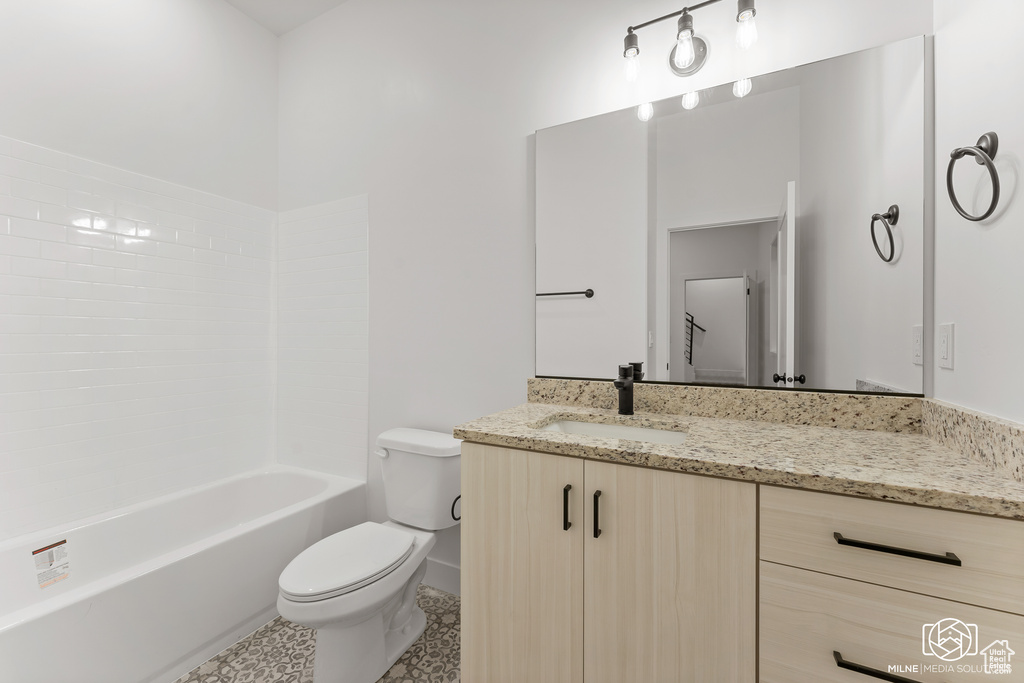 Full bathroom featuring shower / tub combination, vanity, tile patterned flooring, and toilet