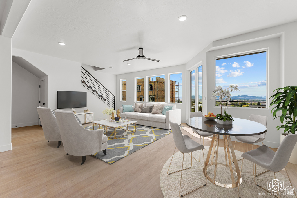 Living room with light hardwood / wood-style flooring and ceiling fan