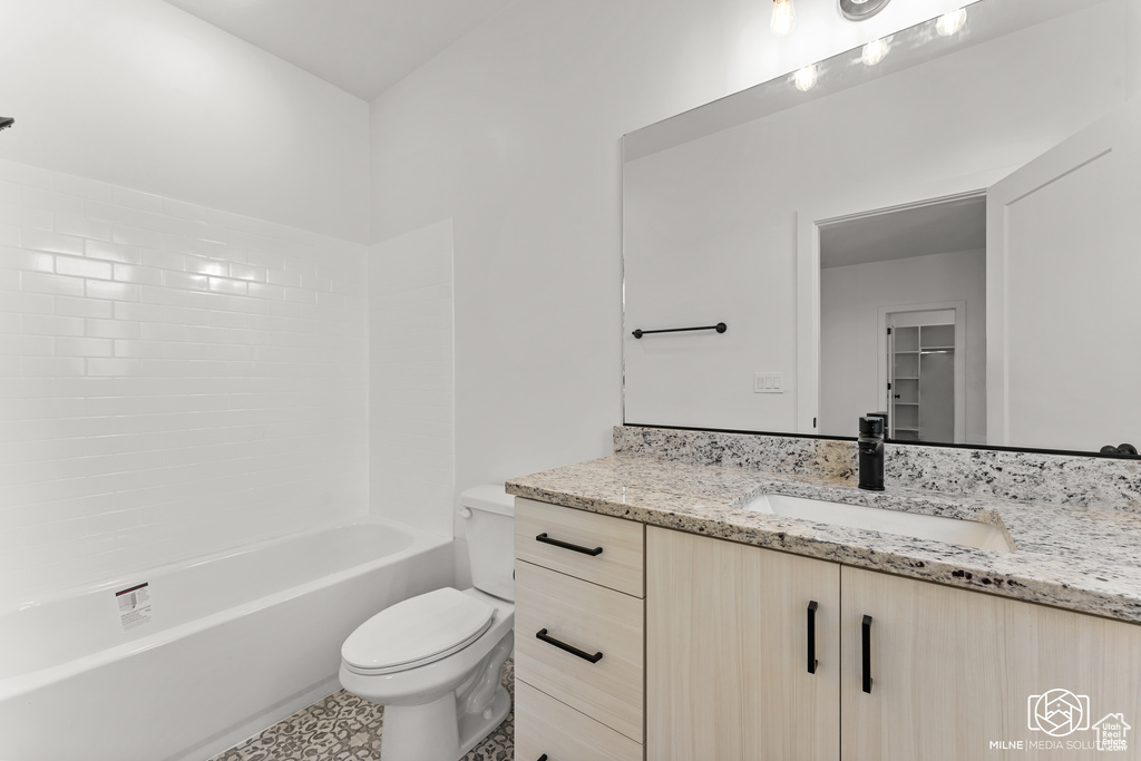 Full bathroom with vanity, toilet, and washtub / shower combination