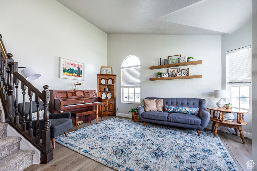 Living room featuring lofted ceiling and hardwood / wood-style floors