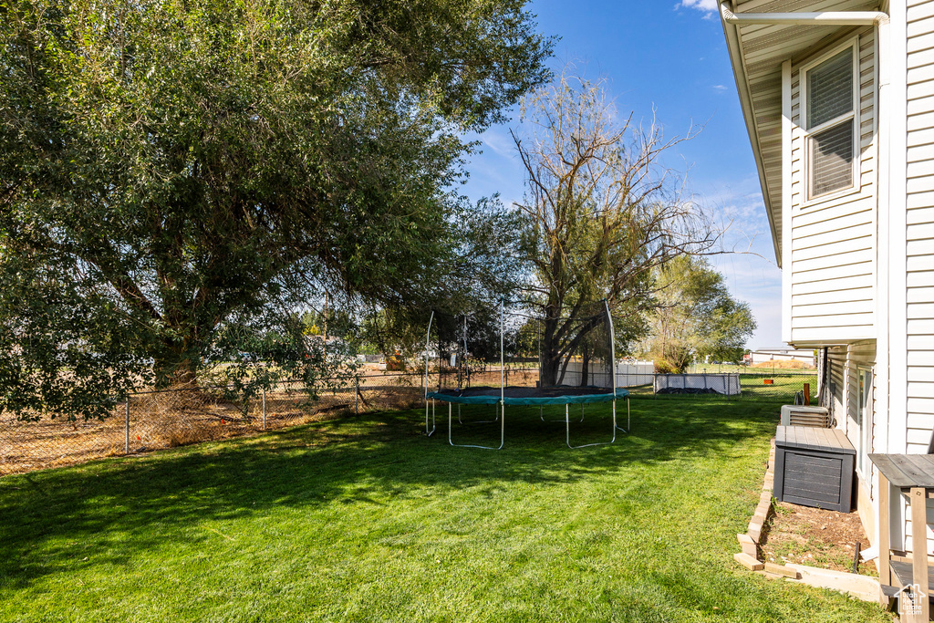 View of yard featuring a trampoline