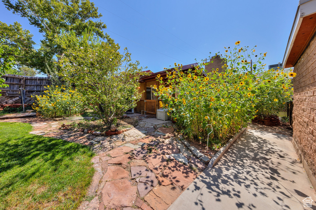 View of yard with a patio area and fence