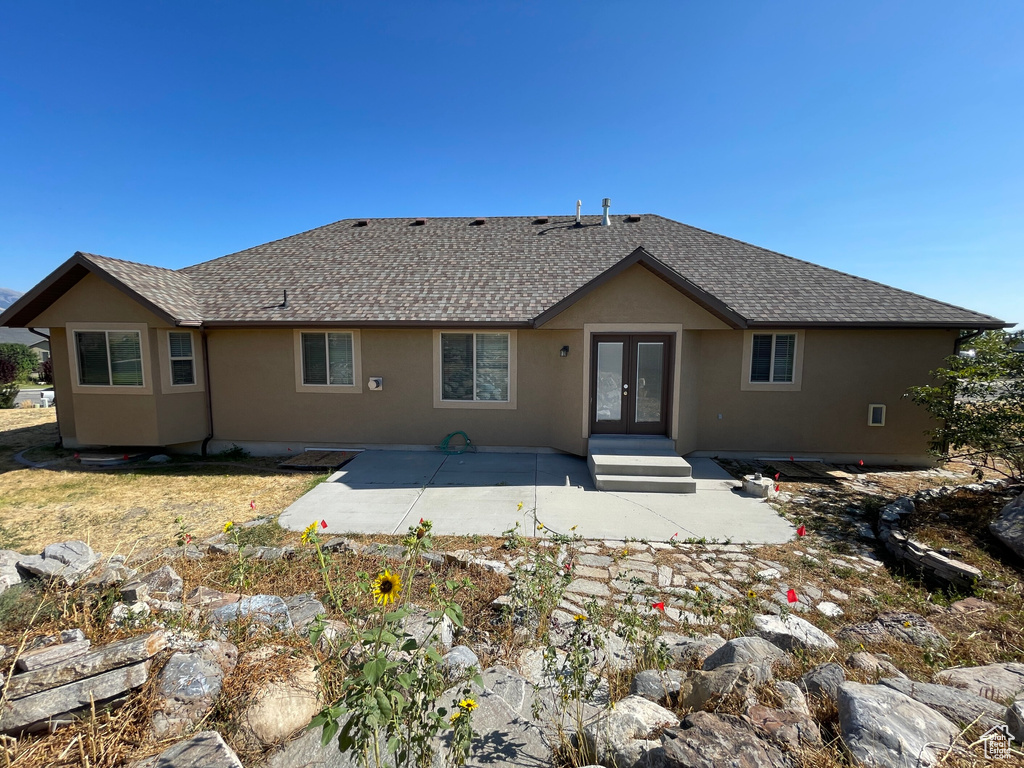 Rear view of house featuring french doors and a patio area