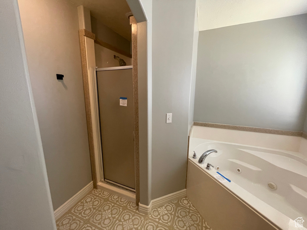 Bathroom featuring separate shower and tub and tile patterned floors