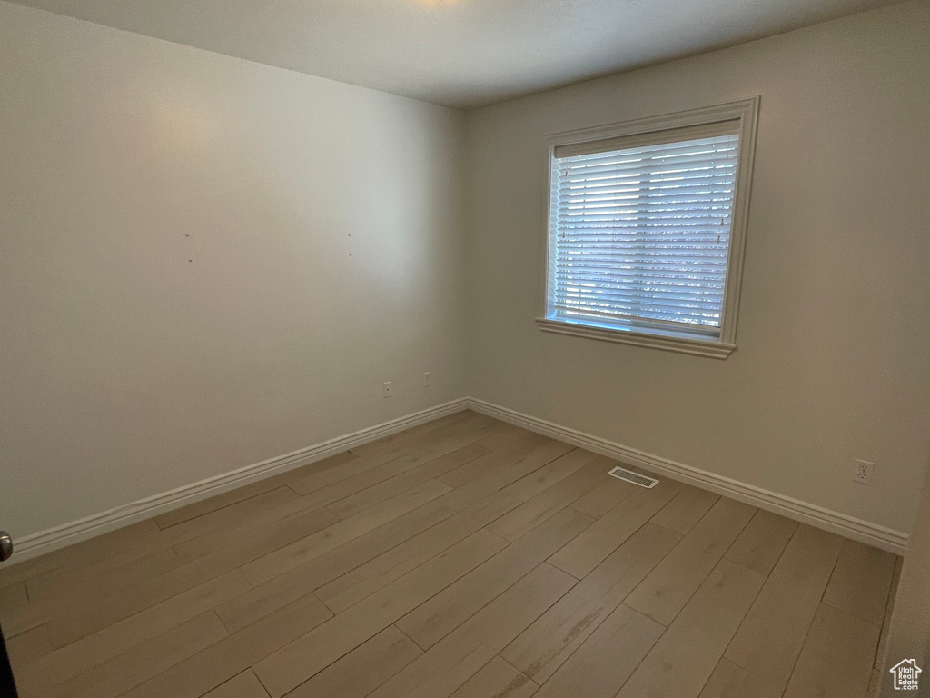 Spare room featuring light wood-type flooring