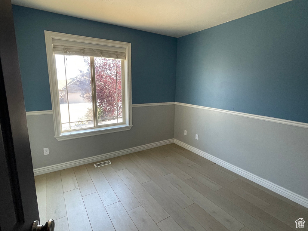 Unfurnished room with light wood-type flooring