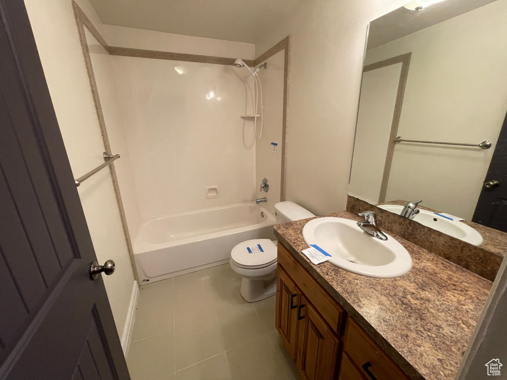 Full bathroom featuring tile patterned flooring, vanity, toilet, and shower / tub combination