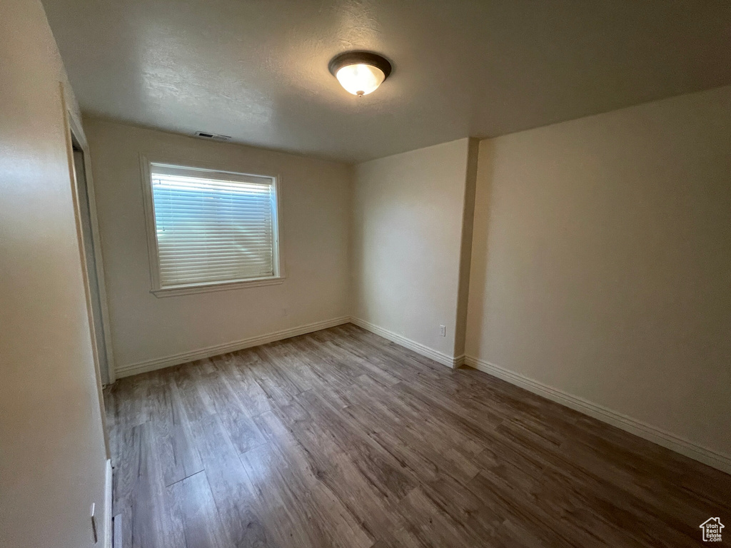 Unfurnished room featuring light wood-type flooring and a textured ceiling