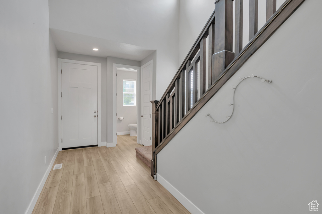 Foyer with light hardwood / wood-style floors