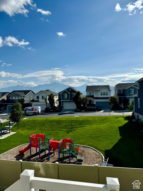 Exterior space featuring a garage, a playground, and a yard