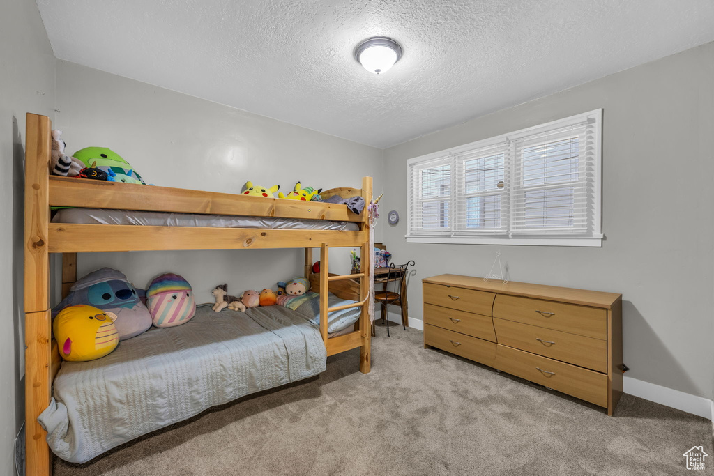 Carpeted bedroom with a textured ceiling