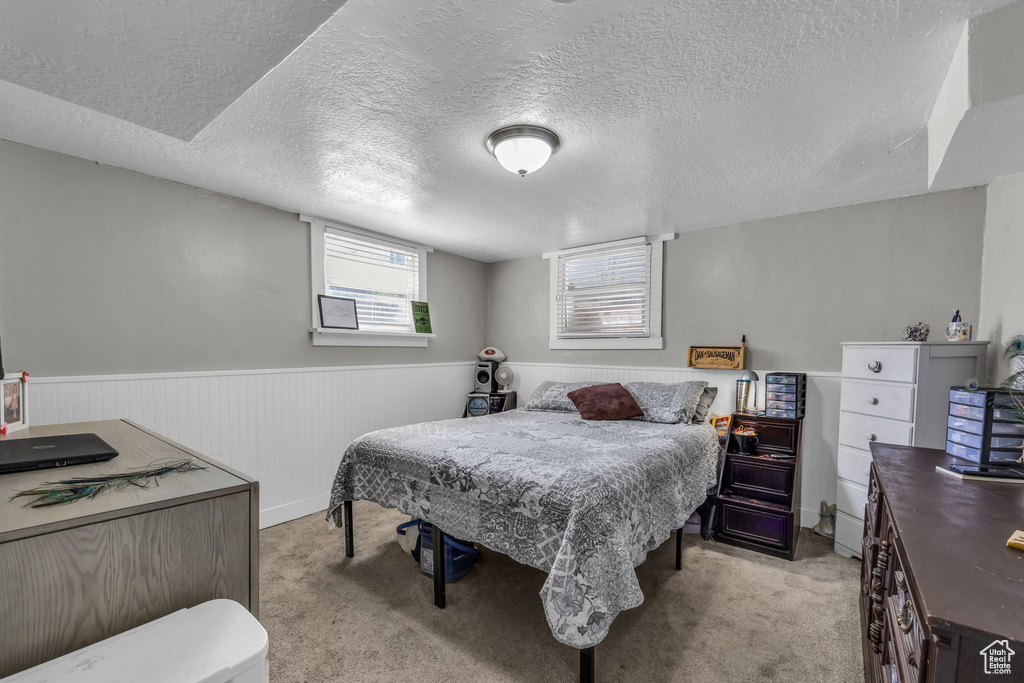 Carpeted bedroom with a textured ceiling