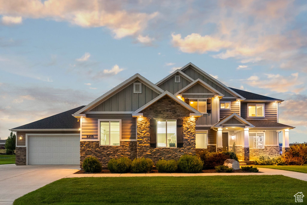 Craftsman-style home with a lawn and a garage