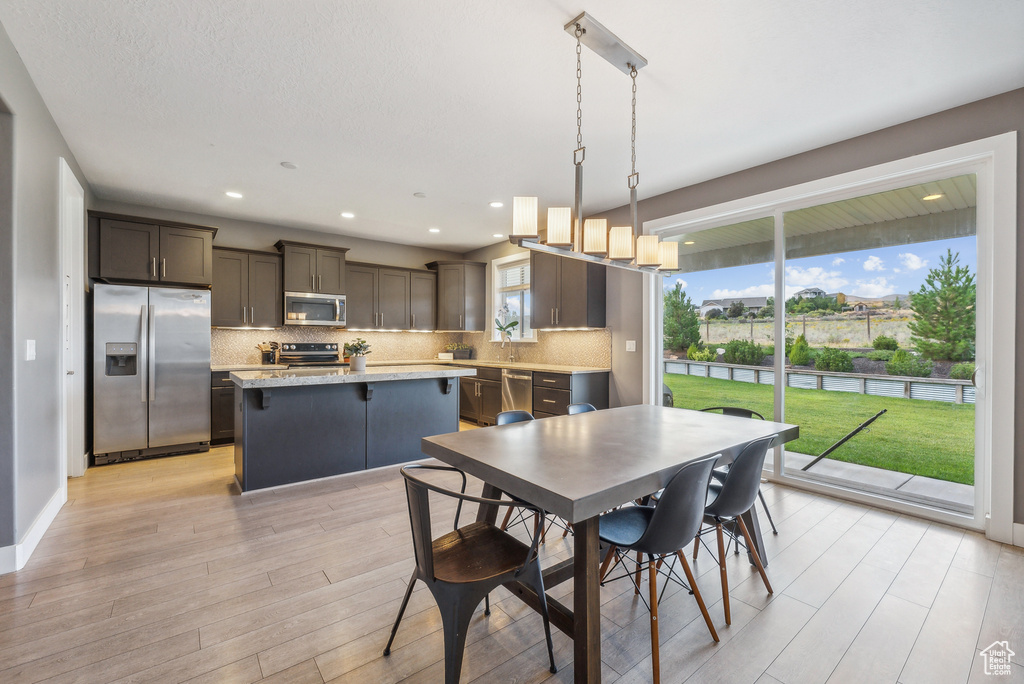 Dining room featuring a chandelier and light hardwood / wood-style flooring