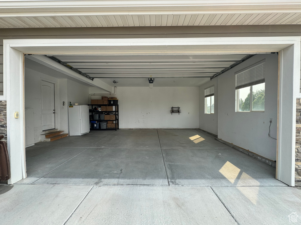 Garage with white refrigerator