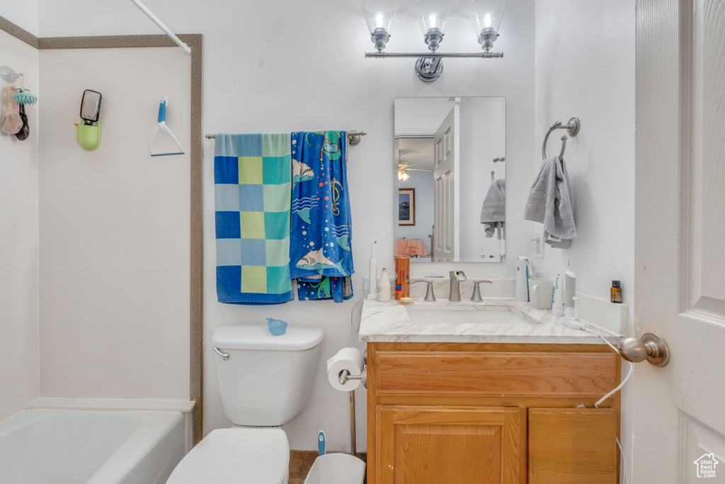 Full bathroom featuring vanity, toilet, and washtub / shower combination