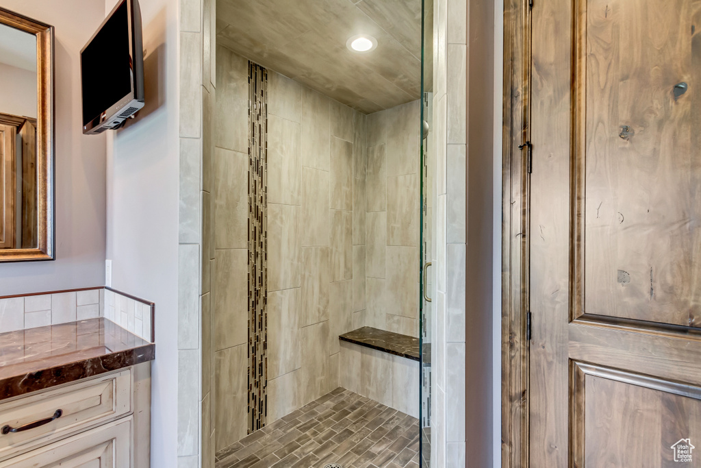 Bathroom with vanity and a shower with shower door