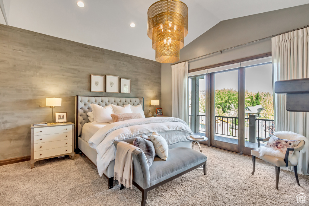 Carpeted bedroom with lofted ceiling and access to outside