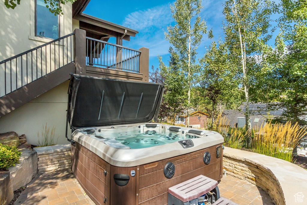 View of patio / terrace featuring a balcony and a hot tub