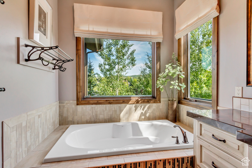 Bathroom with a relaxing tiled tub and vanity