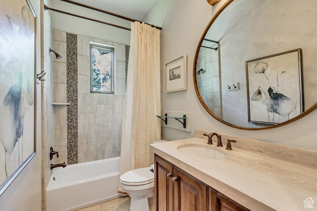 Full bathroom with tile patterned flooring, toilet, shower / tub combo, and vanity