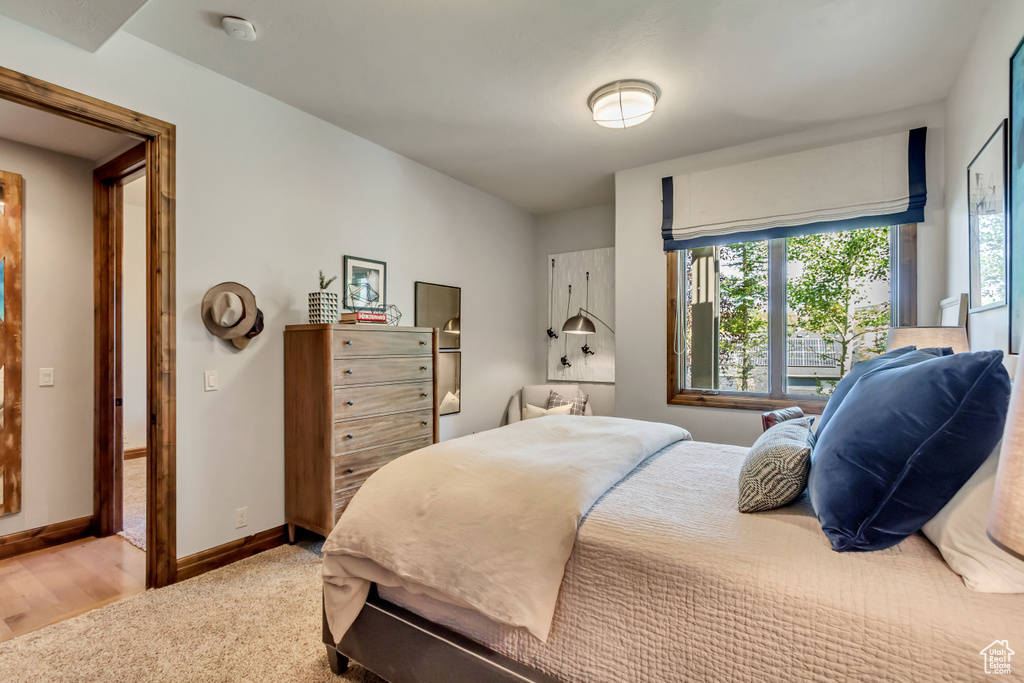 Bedroom featuring multiple windows and hardwood / wood-style flooring