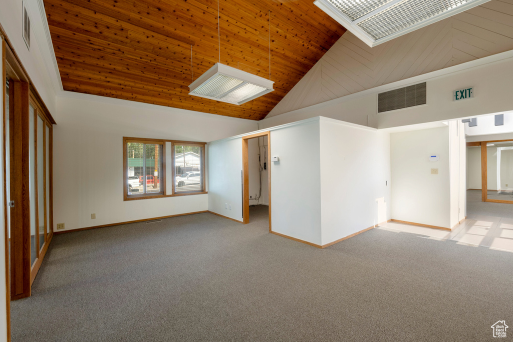 Spare room featuring wooden ceiling, high vaulted ceiling, and carpet