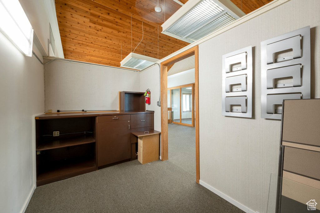 Interior space featuring carpet flooring and wooden ceiling