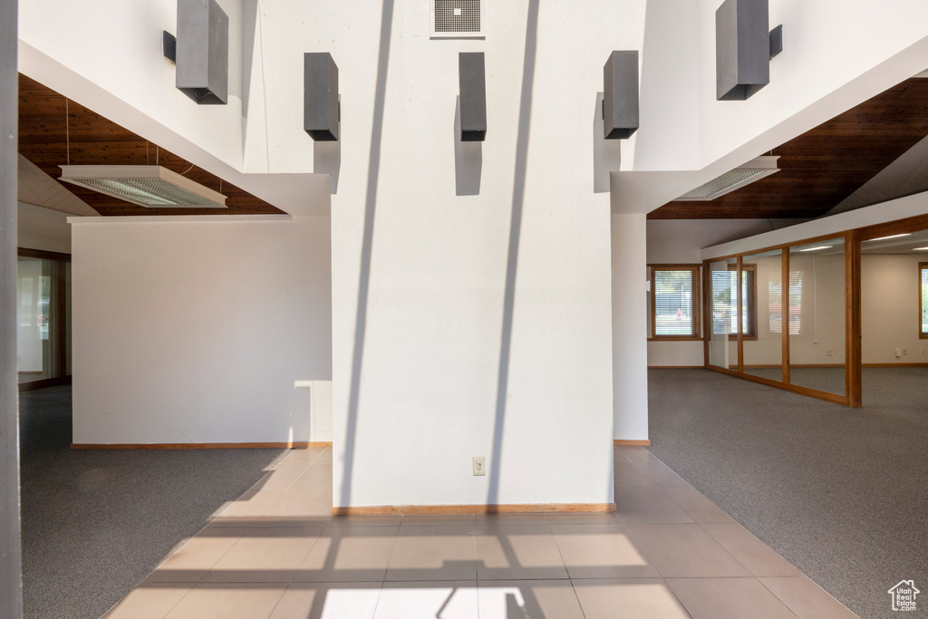 Interior space featuring carpet flooring and a high ceiling