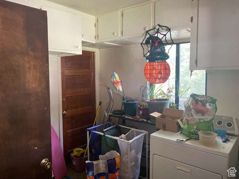 Clothes washing area with washer / dryer and cabinets