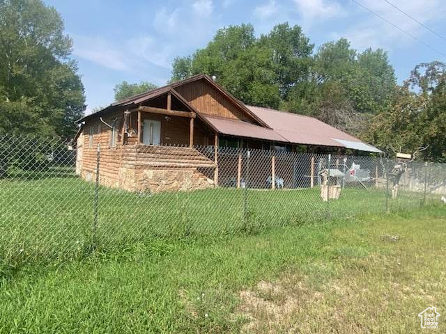 View of side of property with a lawn