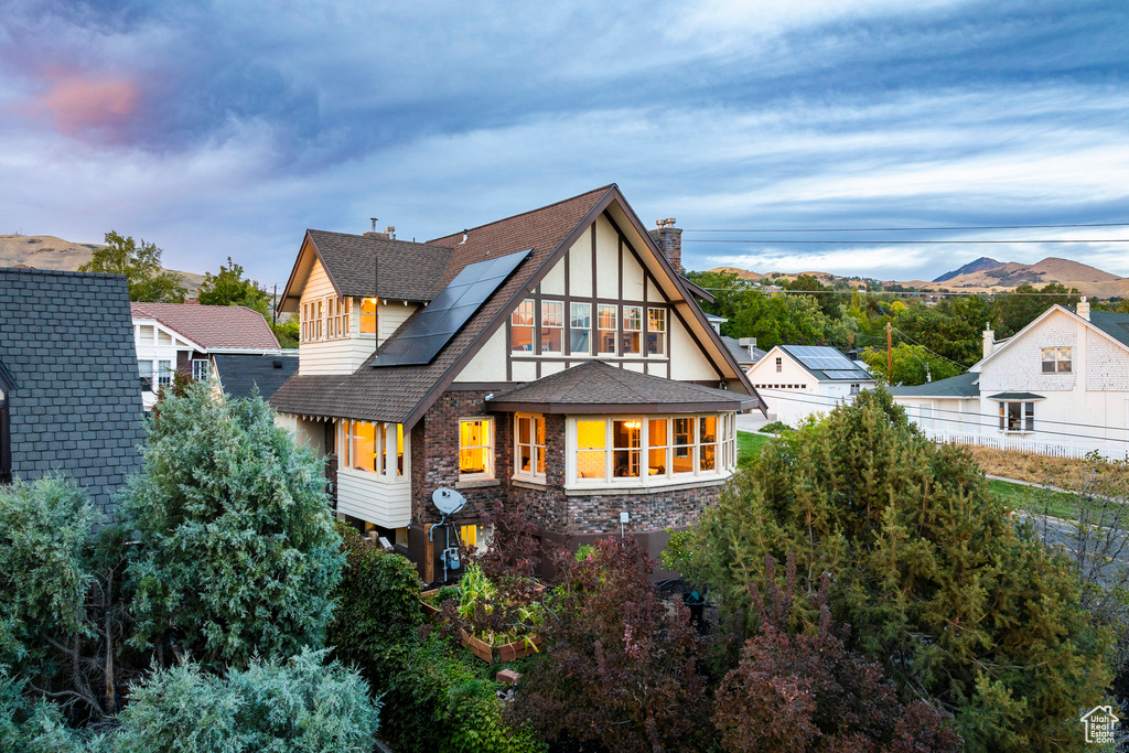 Rear view of house with a balcony and a mountain view