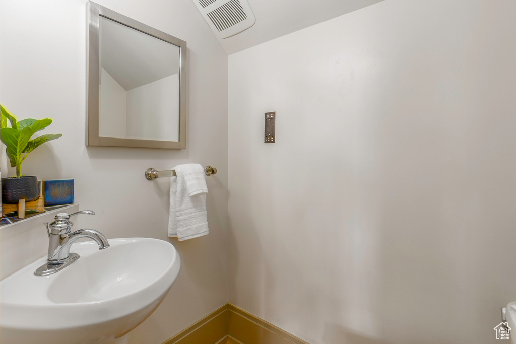 Bathroom with lofted ceiling and sink