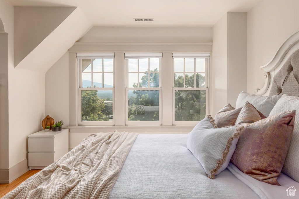 Bedroom with hardwood / wood-style flooring